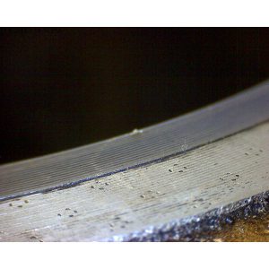 (Photo 2) A Mismatch at the Junction Between the Cast Iron Cylinder Liner and the Aluminum Cast Around It.|(Photo 1) Machining High and Low Spots in the Gasket Surface|